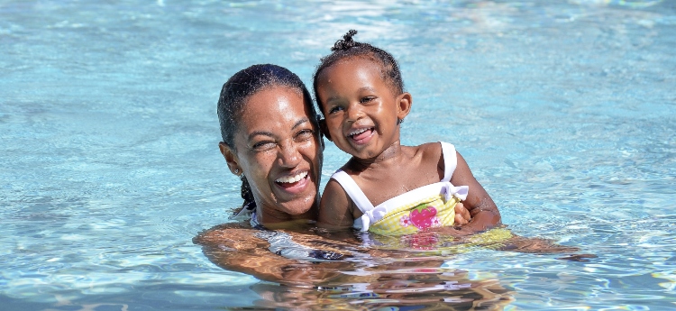 Mom and young daughter in a swimming pool