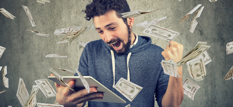 Man with iPad surrounded by falling cash