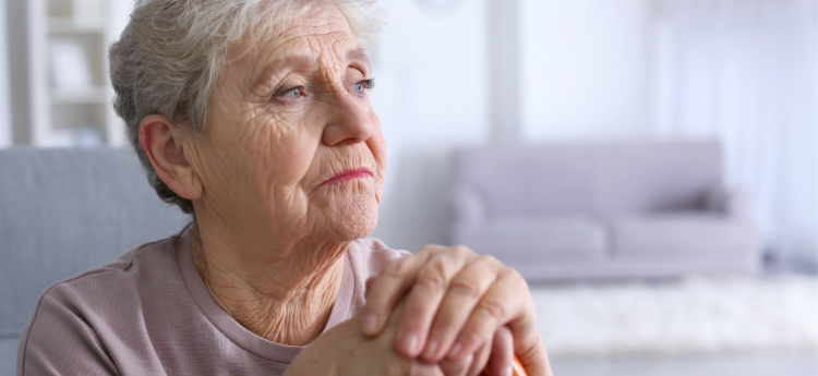 Seated elderly woman staring into the distance